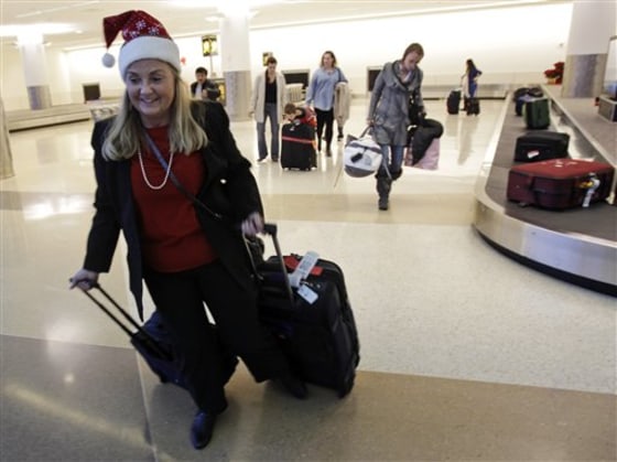 FILE - In this Dec. 21, 2010 file photo, holiday travelers collect their luggage at the San Jose International Airport in San Jose, Calif. Flying over the holidays is going to cost more this year. And the longer you wait to book, the pricier it’s likely to get. (AP Photo/Marcio Jose Sanchez, File)